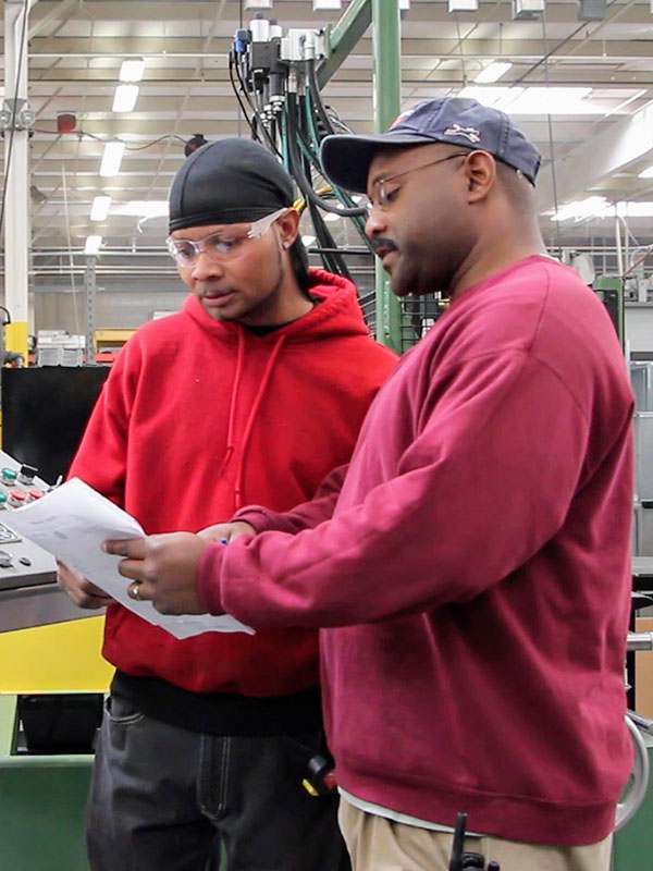 Two employees looking over paperwork