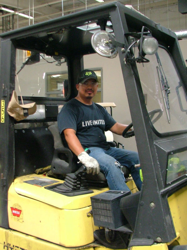 Employee driving forklift