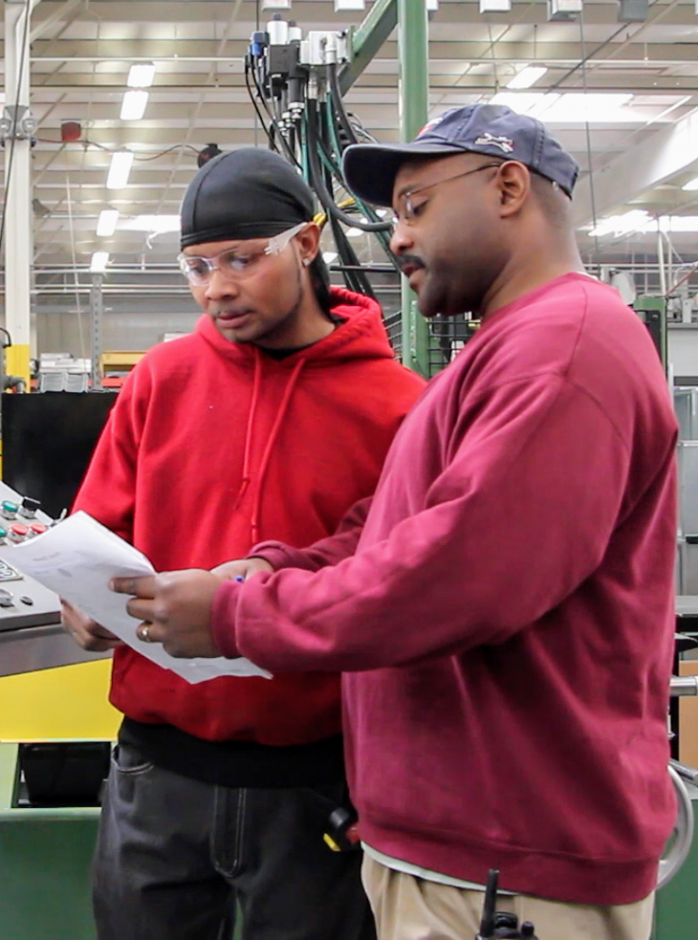 Two employees looking over paperwork